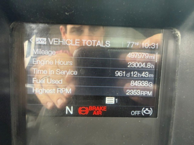 Vehicle totals display on Mack PI64T cab dash showing mileage 497,979 mi, engine hours 23,004.8 h, time in service 961d12h43m, fuel used 84,938 gal, highest RPM 2,353 RPM, N brake status.