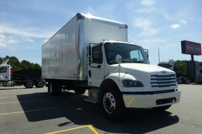 Truck cab and box body showing Freightliner M2 106 with box truck cargo area in a dealership lot.