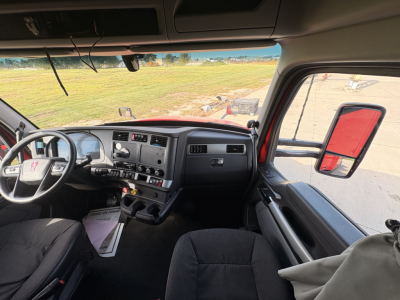 Kenworth T680 truck interior dashboard and steering wheel with side mirror view.