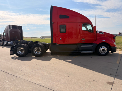 Kenworth T680 sleeper tractor in red side profile showing cab, fuel tanks, and six-wheel rear axle