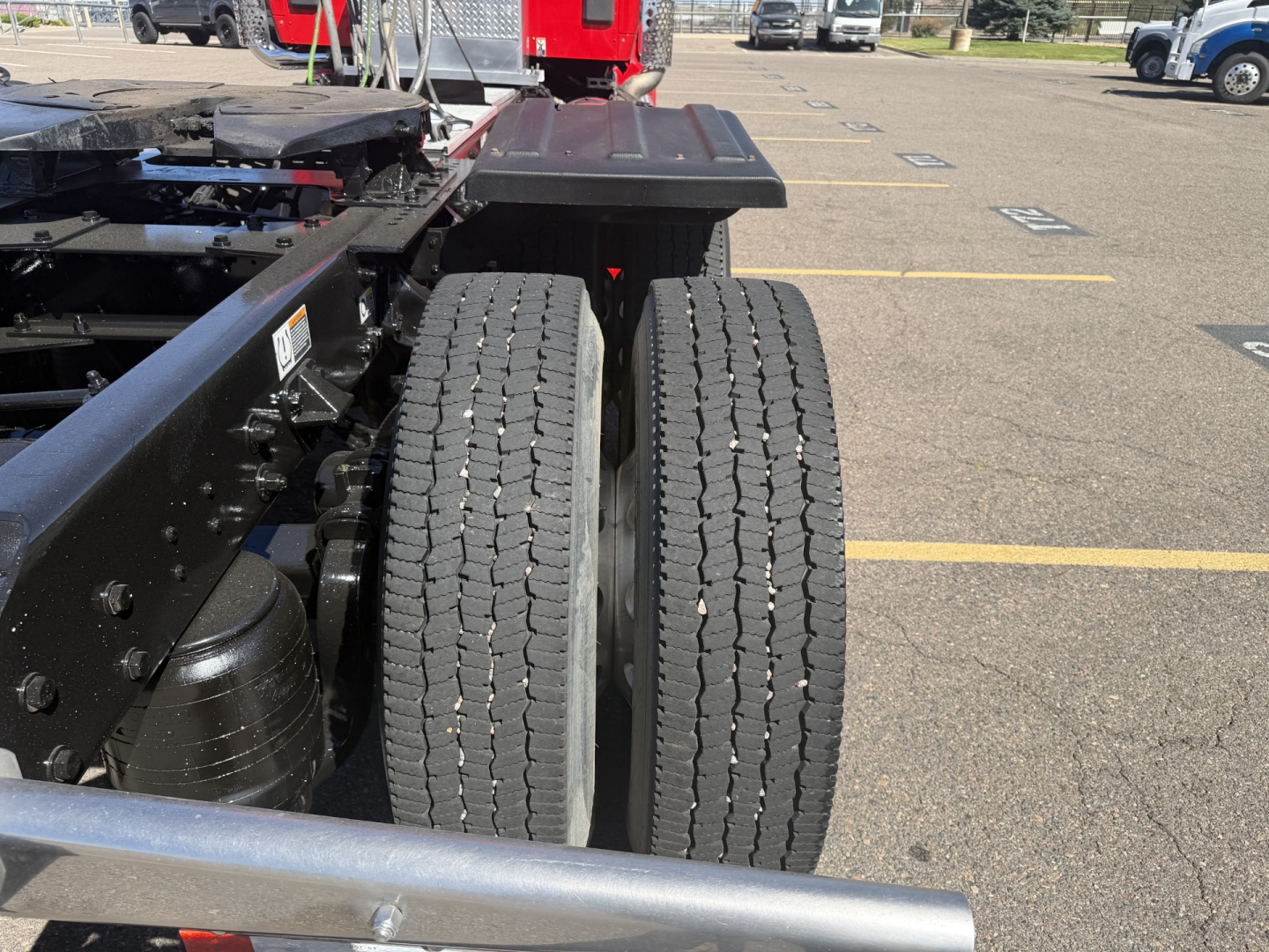 Kenworth T880 chassis rear view showing dual rear wheels and frame components.