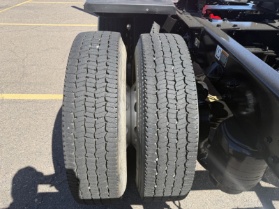 Dual rear truck tires on Kenworth T880 chassis showing tread pattern and wheel wells.