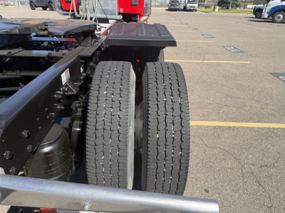 Kenworth T880 chassis rear view showing dual rear wheels and frame components.