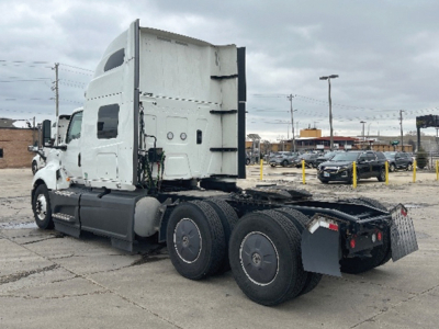 International LT625 tractor in a truck lot showing sleeper cab and rear axle with dual tandem wheels and hitch.