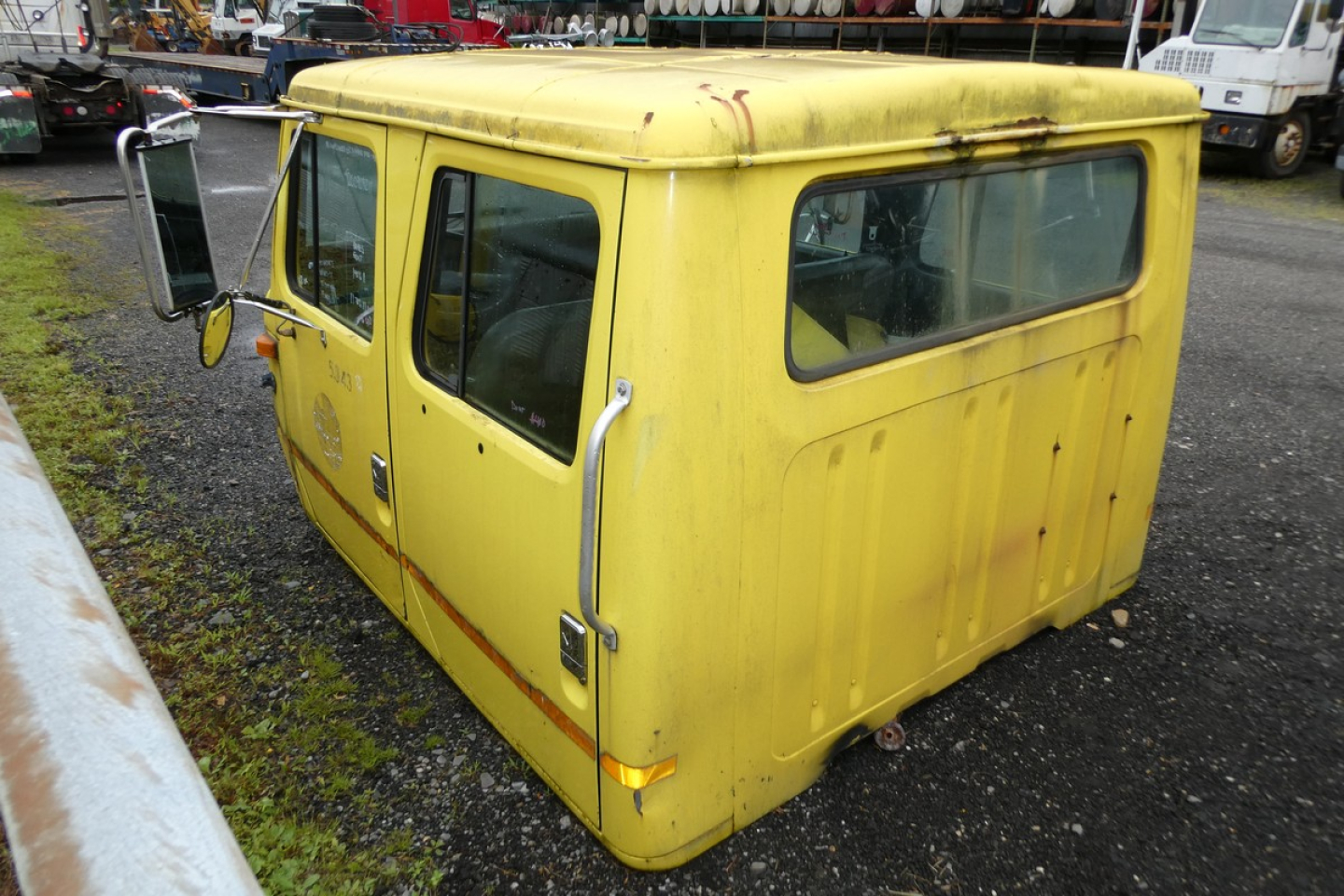 International 4700 quad cab yellow truck cab showing side and rear view.