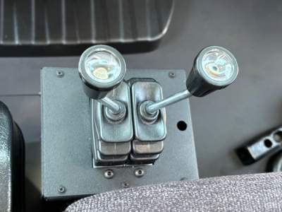 Truck interior accessory with two joystick-style levers and round indicator lights mounted on a rectangular base