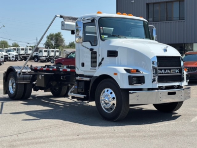 Mack MD7 hooklift truck showing front grille and side profile with white cab and hooklift setup.