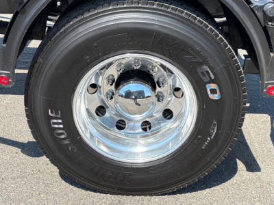 Mack MD7 wheel and tire showing Goodyear tire with chrome hubcap and lug nuts.