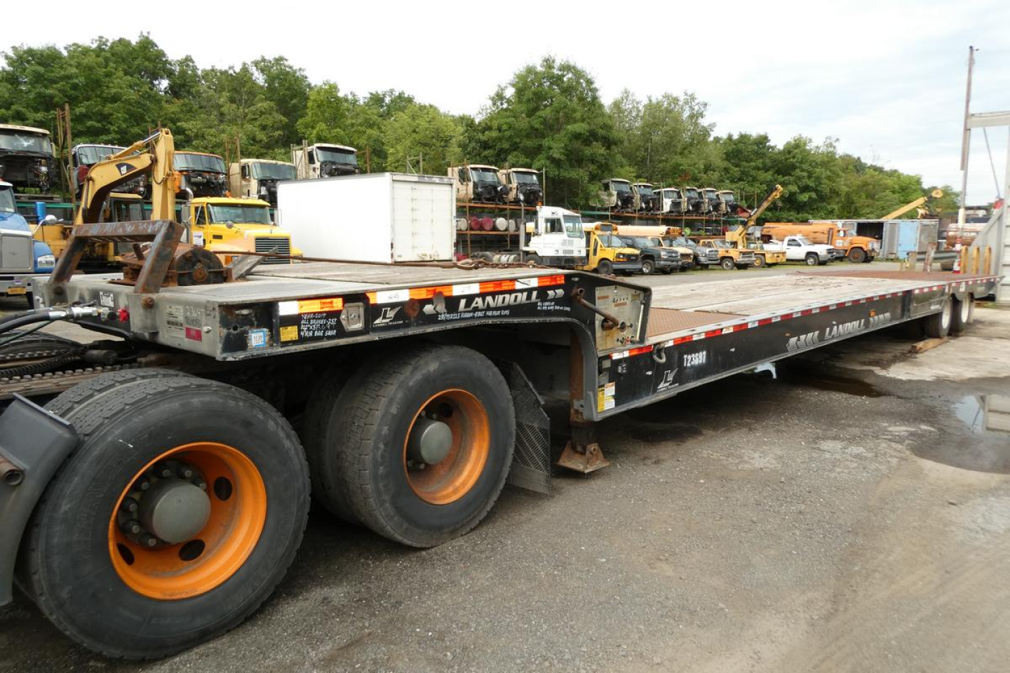 Landoll 930D NGL trailer showing dual rear axles with orange rims and flatbed deck.