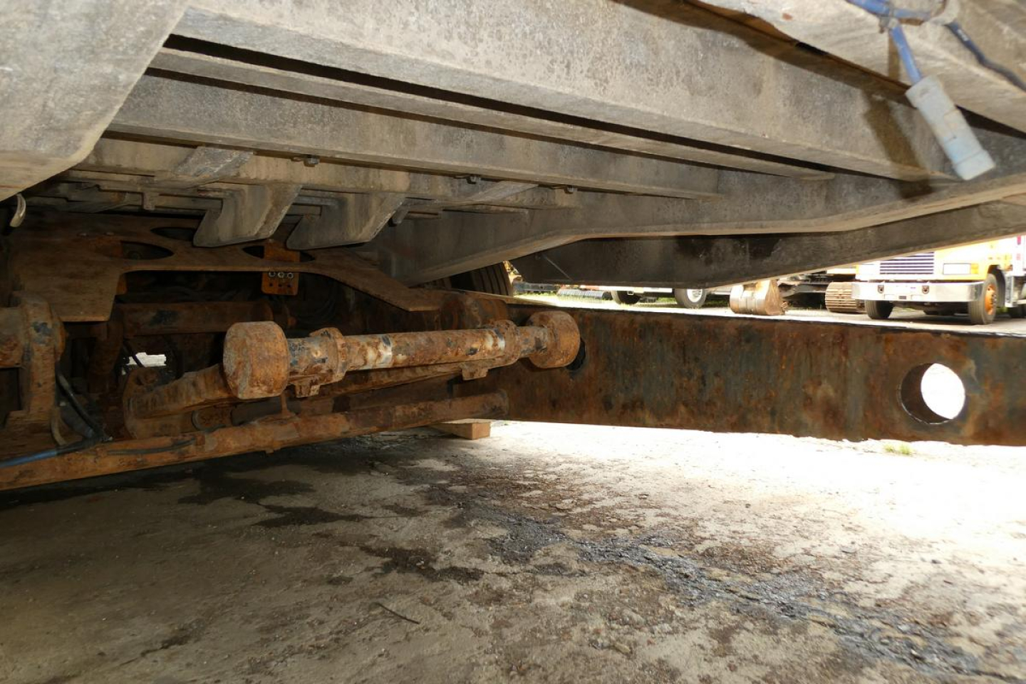 Underbody view of a Landoll 930D NGL trailer showing rusty undercarriage and axle components.