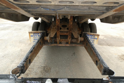 Trailer rear view showing landing gear and frame undercarriage of a 2017 Landoll 930D NGL trailer with rusted steel beams and support brackets.