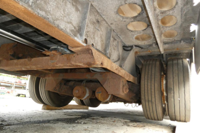 Landoll 930D NGL trailer undercarriage showing dual rear wheel set and suspension components.