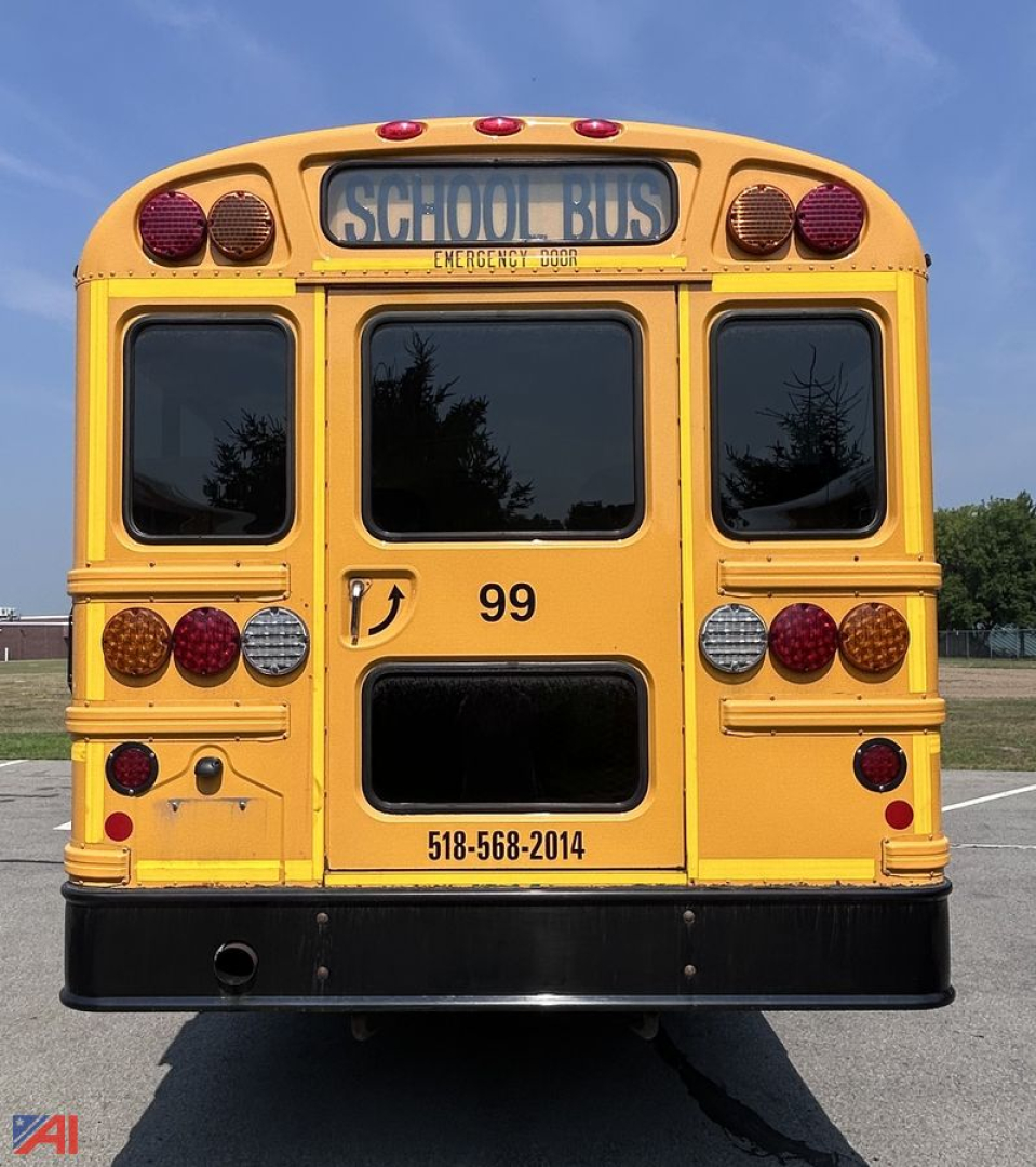 Rear view of a yellow 2020 IC CE Series school bus showing taillights, rear window, number 99, and contact number on bumper.