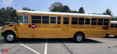 School bus side view showing a yellow 2020 IC Corporation CE Series bus with STOP sign and school district markings.