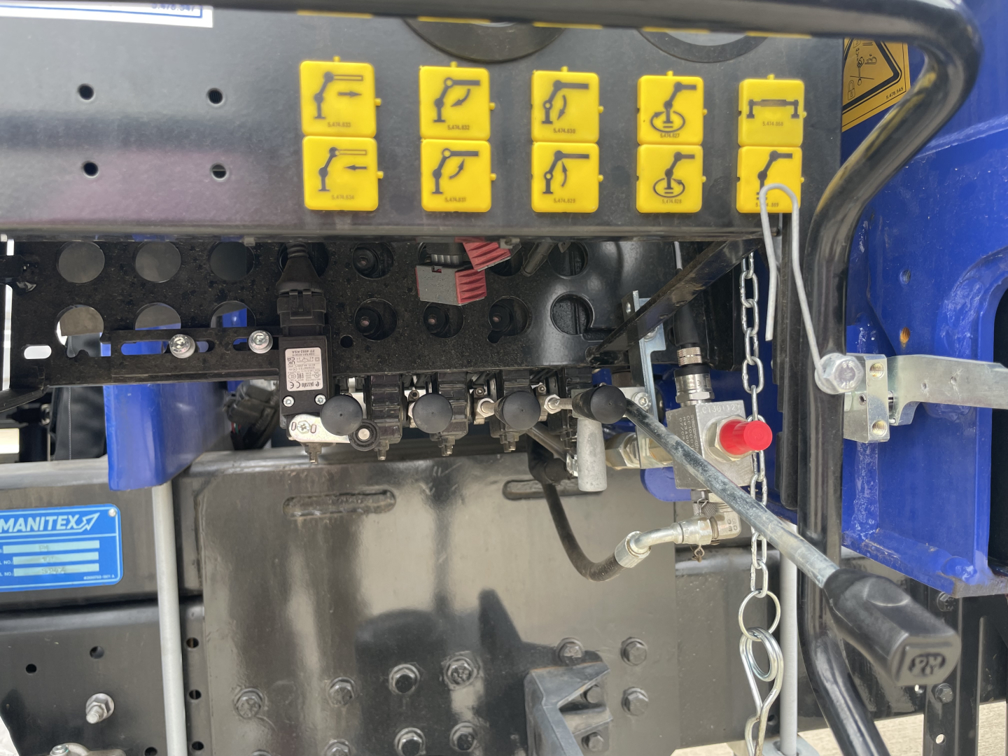 Mack MD7 truck cab interior controls and dashboard area with yellow hazard buttons and various gauges. 