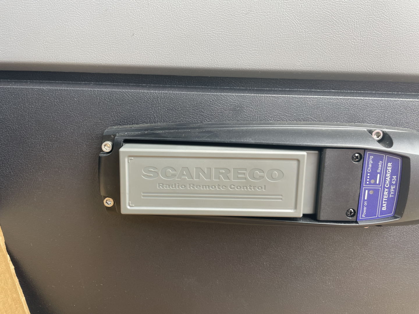 Scanner: ScanRECO remote control panel with label visible on a Mack MD7 boom truck side panel.