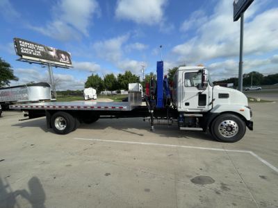 Truck: 2025 Mack MD7 boom truck in-profile view showing cab and long flatbed with crane equipment.