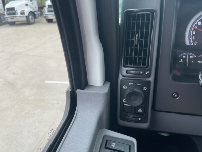 Cab interior of a 2025 Mack MD7 showing dashboard controls and partial gauge cluster.