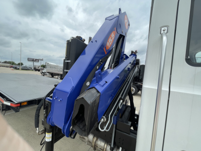 Mack MD7 boom truck arm in blue folded on a white cab; visible labels include 65 and hydraulic components