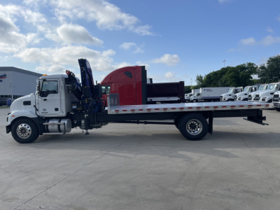 Mack MD7 boom truck side view showing flatbed w/ hydraulic crane and cab interior visible