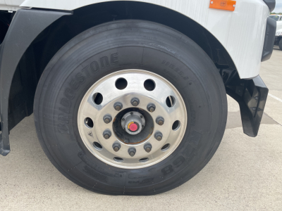 Mack MD7 truck front wheel showing Bridgestone tire and silver alloy rim with hub cap.