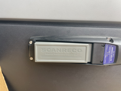 Scanner: ScanRECO remote control panel with label visible on a Mack MD7 boom truck side panel.