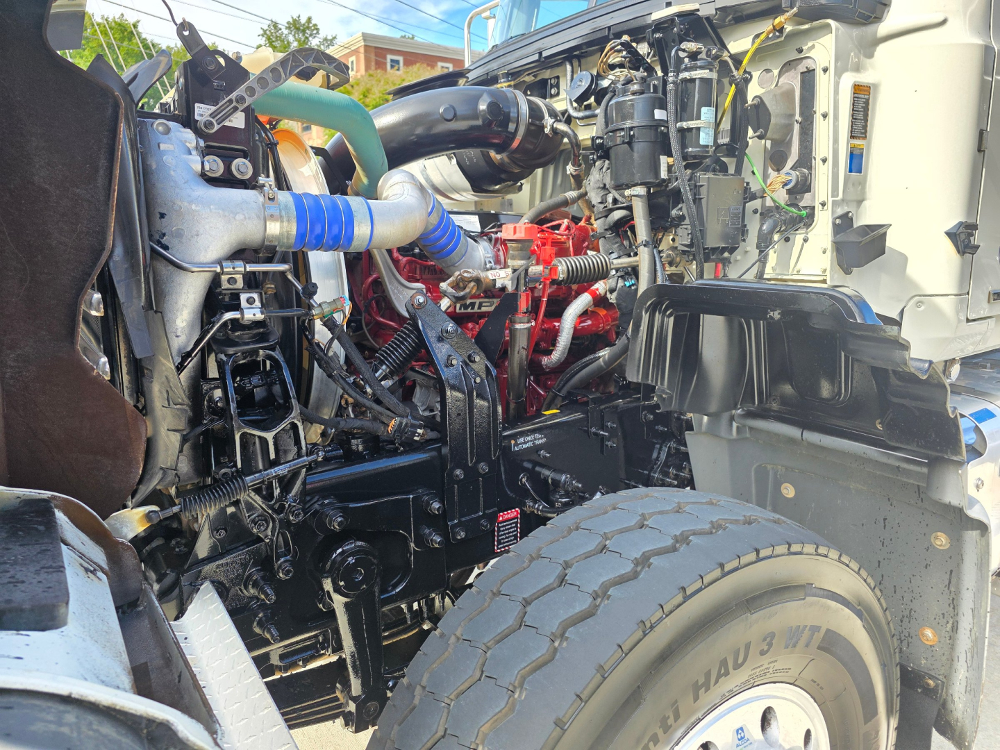 Mack GRANITE engine bay showing large V8 diesel engine, hoses, and components