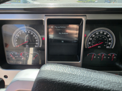 Dashboard of a 2022 Mack Granite truck showing speedometer on left, center screen with no notices, and gauge cluster on right.