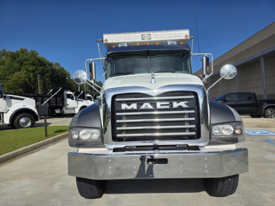 Front view of a 2022 Mack Granite dump truck showing large chrome grille with MACK lettering, chrome bumper, round mirrors, and cab lights.