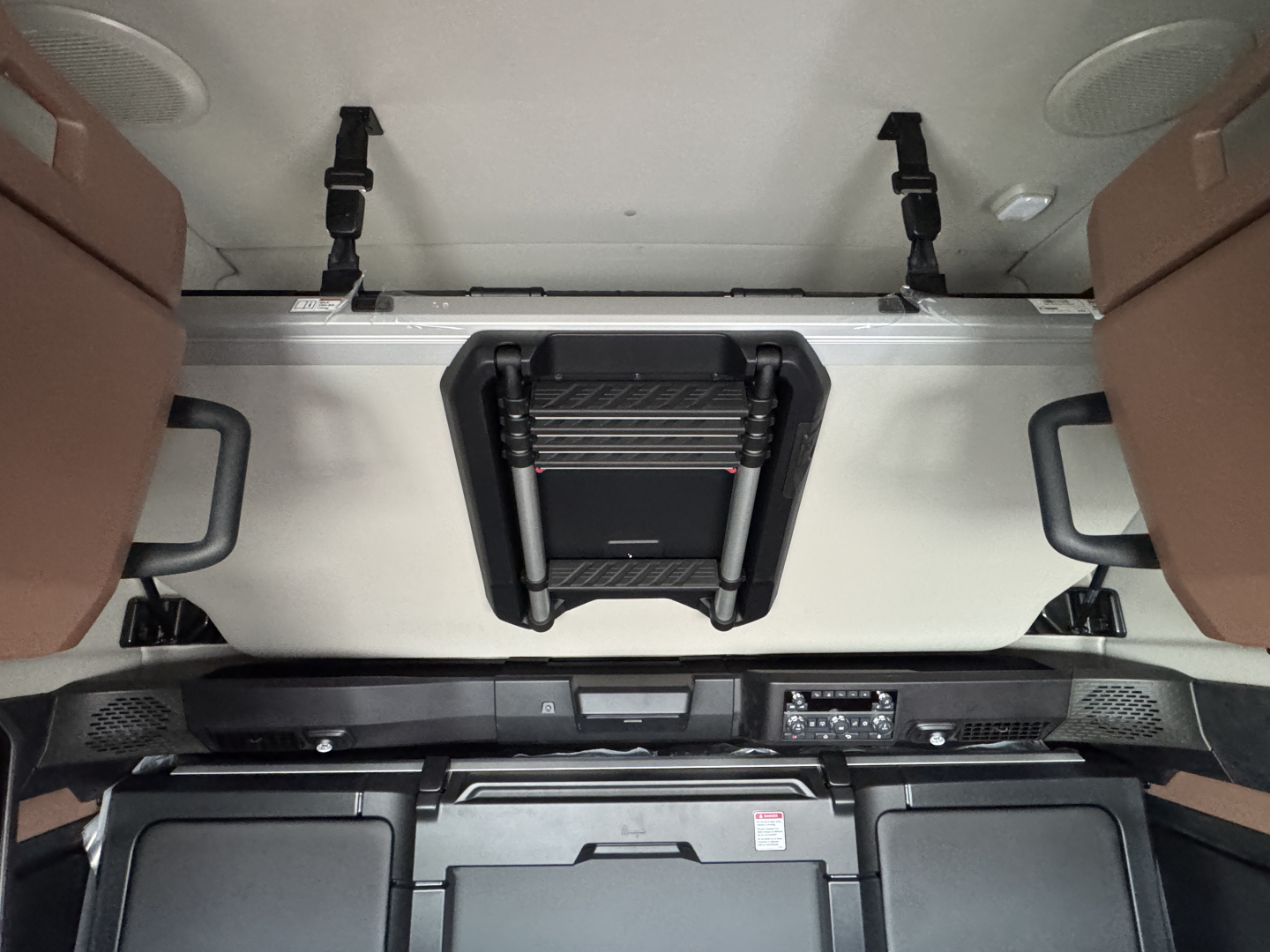 Front interior cab area of a 2026 Mack PR64T76H truck showing overhead sleeper area with vents, controls, and dash details.