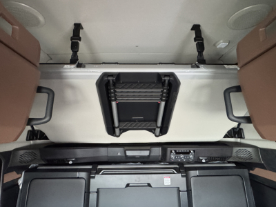 Front interior cab area of a 2026 Mack PR64T76H truck showing overhead sleeper area with vents, controls, and dash details.