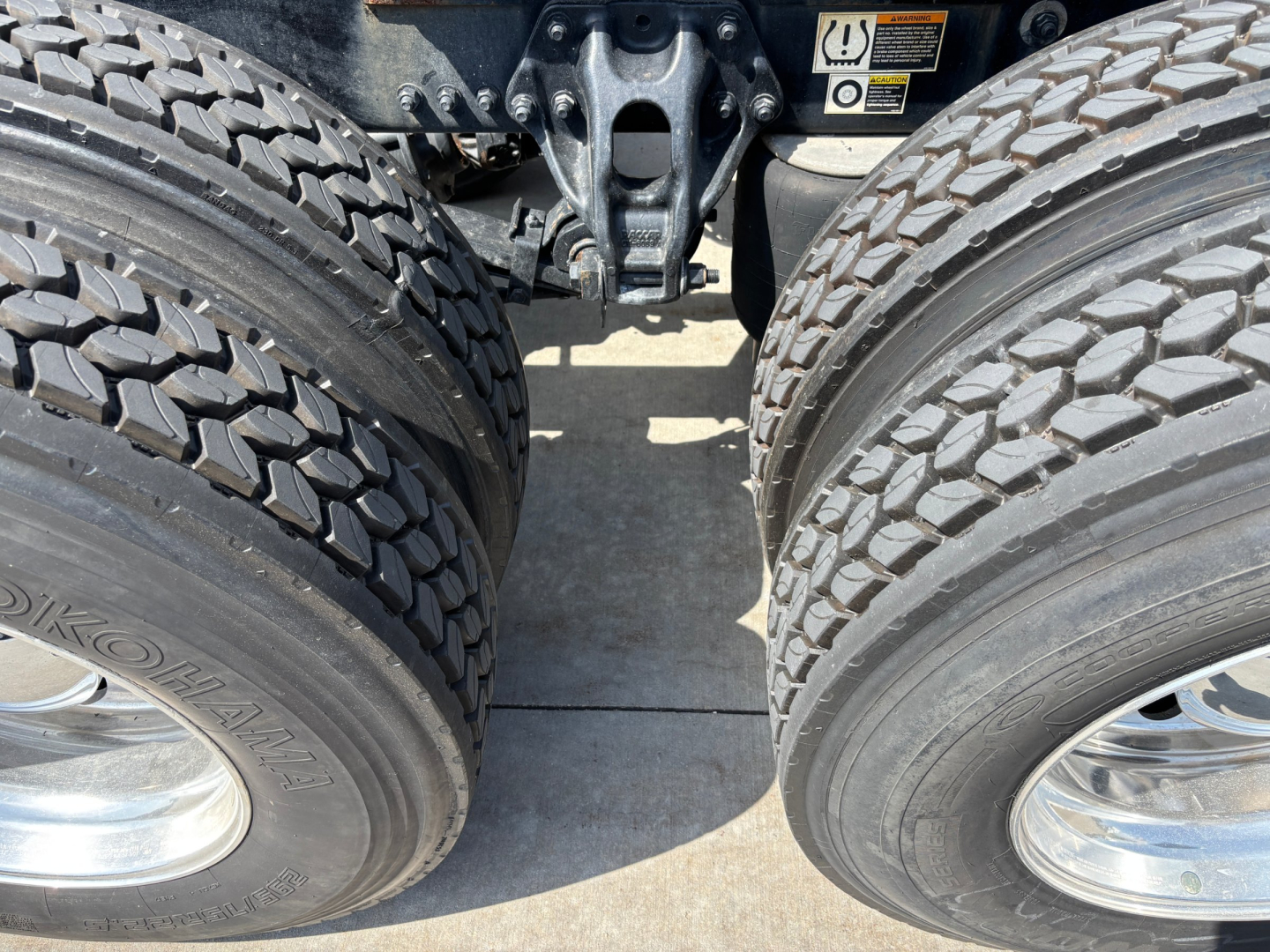 Kenworth T680 rear dual tires and chassis area showing dual rear axle and suspension components.