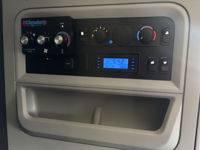 Kenworth T680 dash cluster showing DClimate control panel with knobs, digital display, and vents.