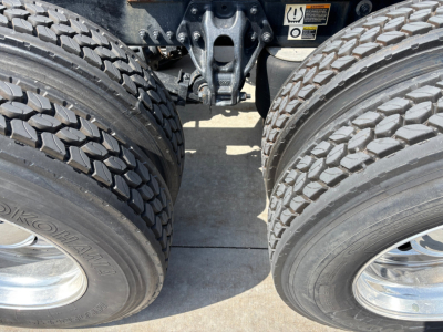 Kenworth T680 rear dual tires and chassis area showing dual rear axle and suspension components.