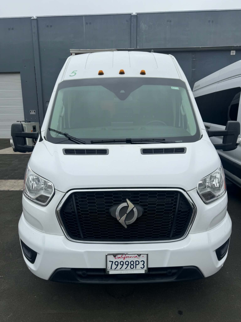 Ford Transit 350 HD XLT front view showing black grille with emblem, three-lamp hood vents, large windshield, California plate 79998P3, side mirrors, and roof vents.