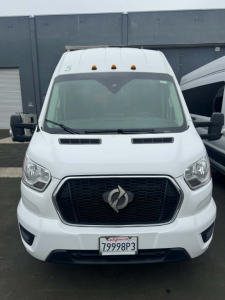 Ford Transit 350 HD XLT front view showing black grille with emblem, three-lamp hood vents, large windshield, California plate 79998P3, side mirrors, and roof vents.