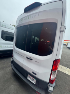 Ford Transit 350 HD XLT rear view showing back doors and taillight, VIN plate area not fully visible.