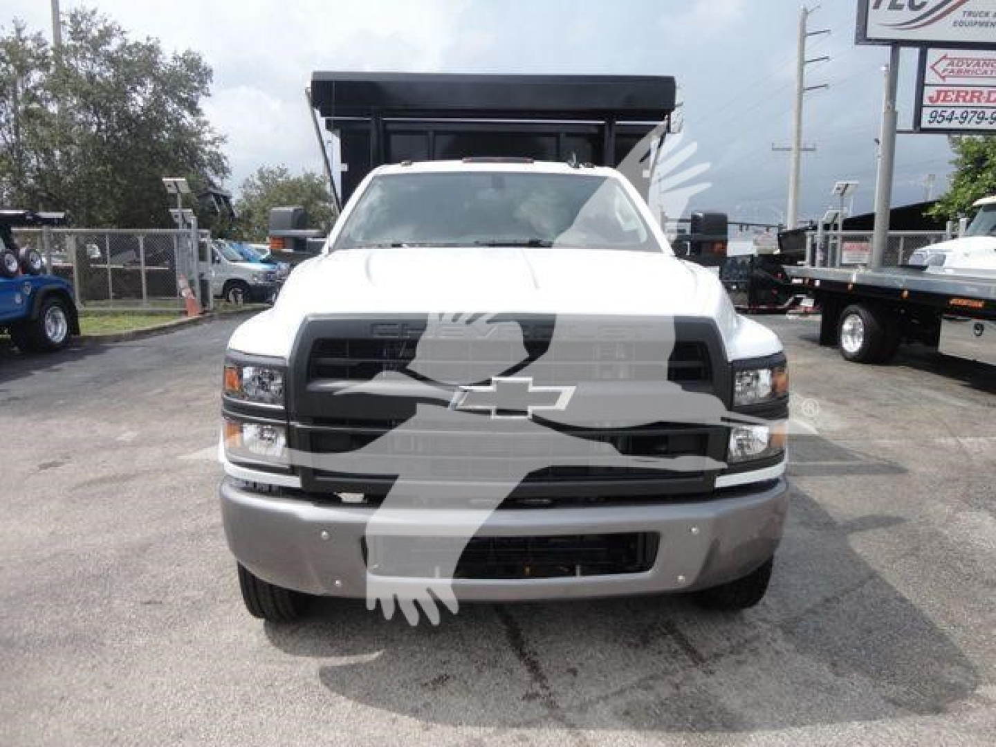 Chevrolet Silverado 5500HD front view with dump bed in a dealership lot, stock SIL550014SNG