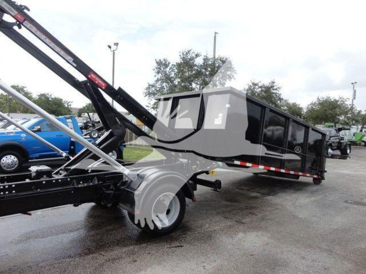 Truck bed with dump/dump trailer and hydraulic arm showing a Silverado 5500HD in-service. Rolloff truck body with black panels and side rails.