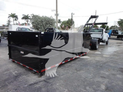 Truck in a dealership lot with a large black roll-off container attached to a white Silverado 5500HD chassis in the background. Visible text includes stock number SIL550014SNG and category Rolloff, type Trucks, new/used New.