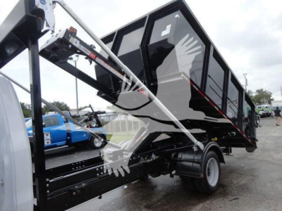 Chevrolet Silverado 5500HD dump body on a roll-off truck showing rear wheel and hydraulic arm assembly