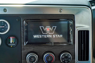 Dashboard view showing Western Star display screen with logo and control knobs in a vehicle interior