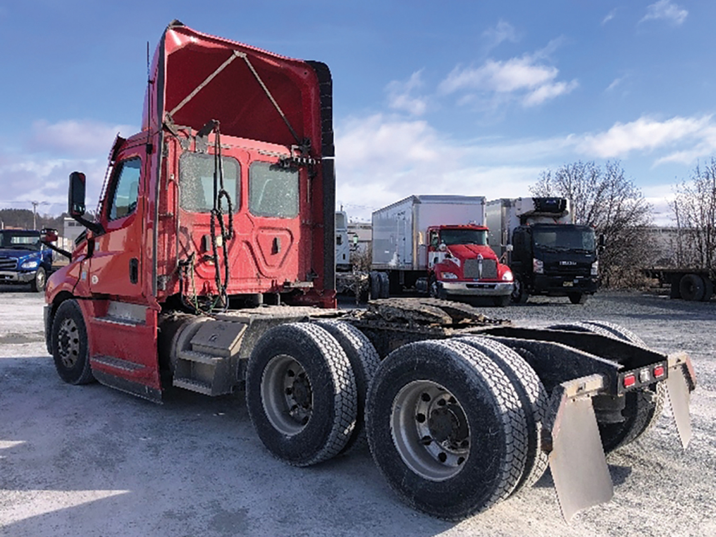 Truck cab and rear chassis of a red 2020 Freightliner Cascadia126 tractor showing the cab, exhaust, and dual rear axles with trailer hitch area.