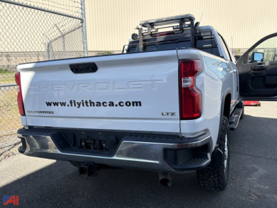 Chevrolet Silverado 2500HD LTZ crew cab pickup with bed rear view showing 'CHEVROLET' badge and plow prep, LTZ badge, and license-free rear bumper.