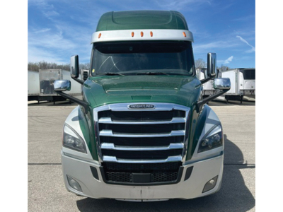 Front view of a green Freightliner Cascadia126 truck with chrome grille and large bumper; no legible warning labels visible.