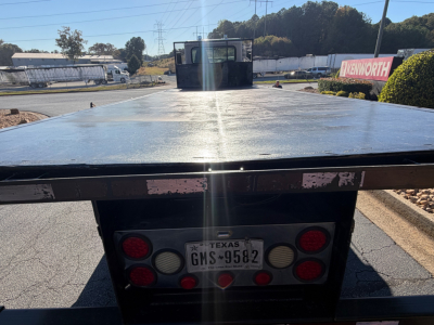 Flatbed truck bed view with Texas license plate GMS-9582 and rear lights, 2007 Peterbilt 335 - Texas inspection plate visible