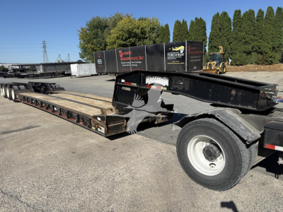 Rogers 50-ton lowboy trailer showing long flatbed with black frame and tandem rear wheels.