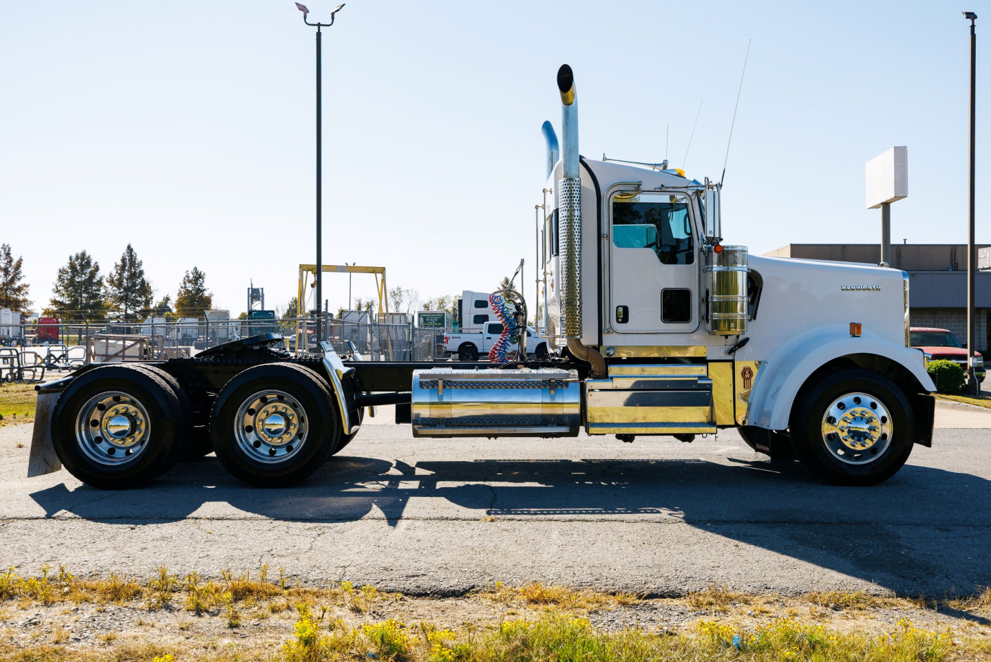 Kenworth W900L semi-truck side view showing chrome exhaust stacks and sleeper cab
