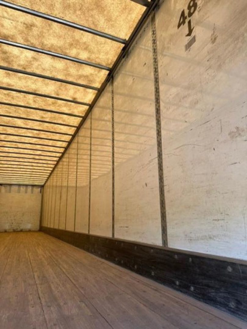 Trailer interior showing wood floor and sidewall panels, labeled numbers along the ceiling.