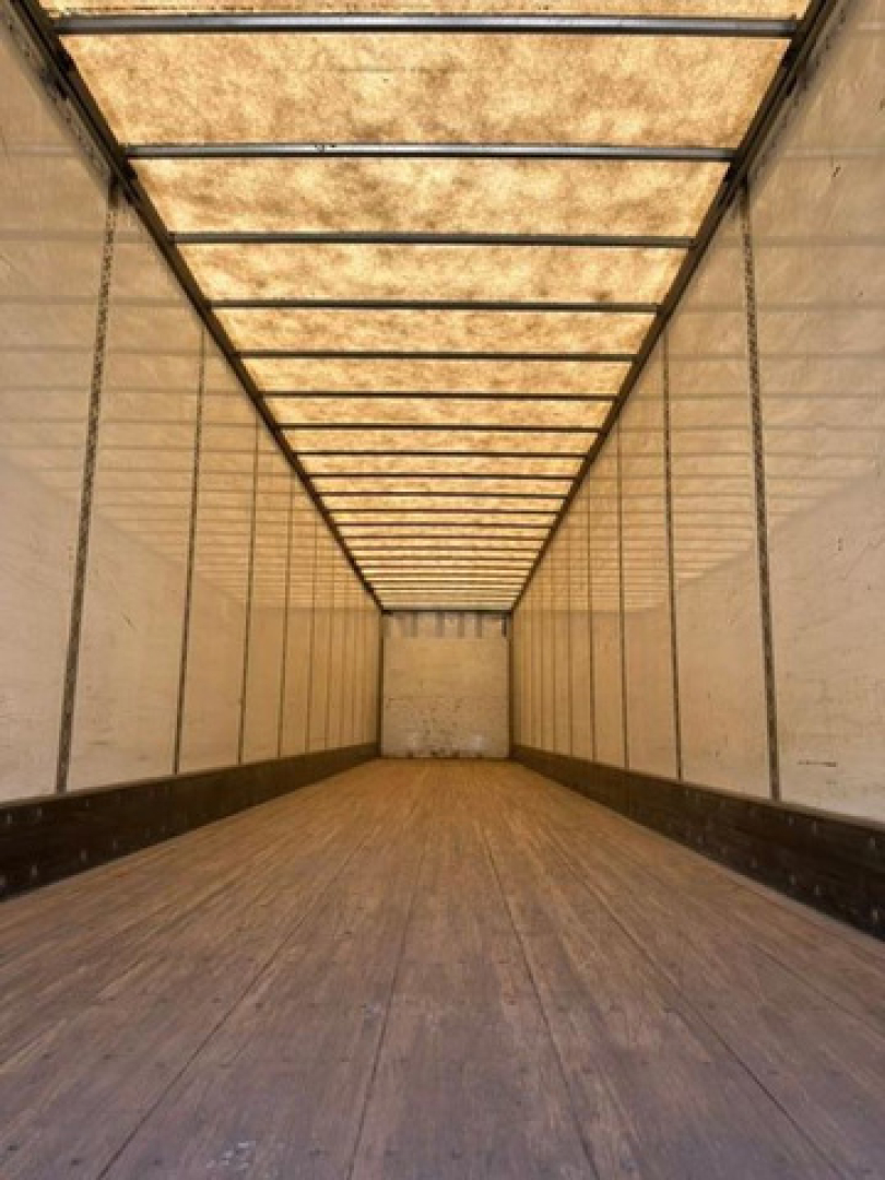 Interior of a 2016 Wabash van trailer with wooden floor and side walls, long empty cargo area